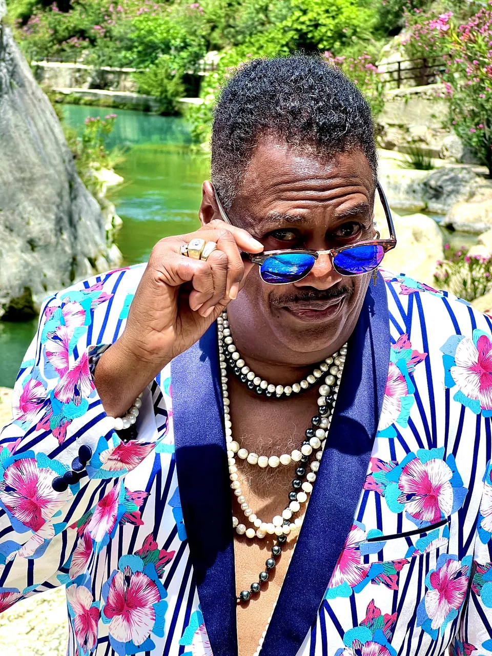 Keith Tynes in a colourful jacket and sunglasses