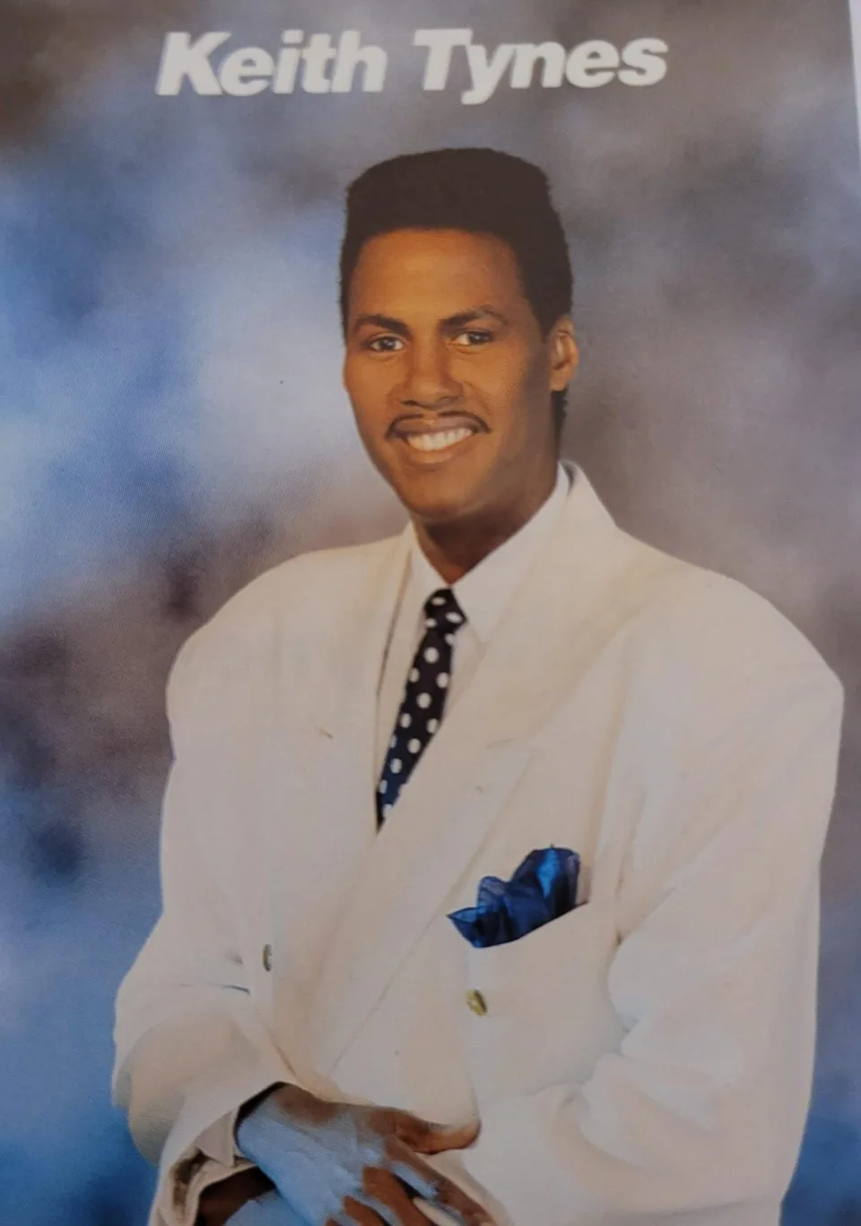 Keith in a white suit in an archival artist photograph