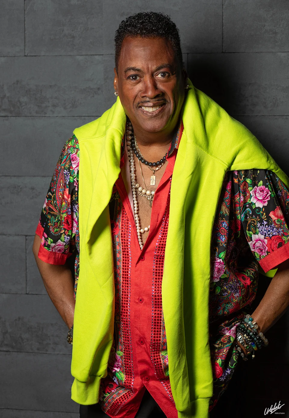 Keith wearing a colourful shirt and a bright yellow sweater