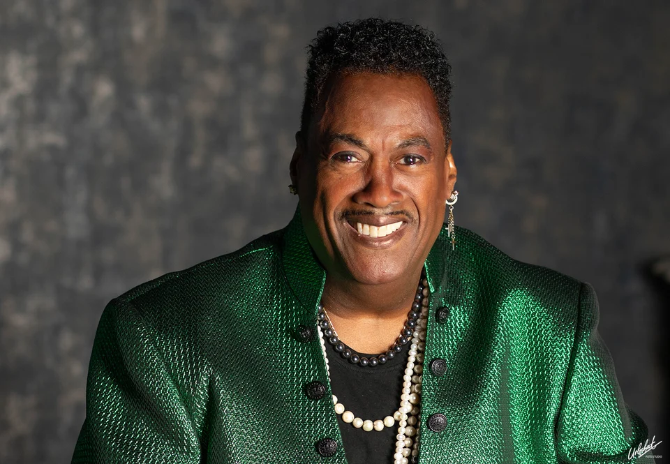 Keith smiling in a sparkling green jacket